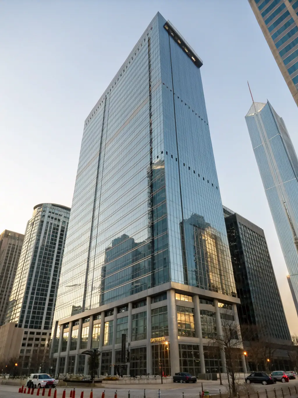 A high-resolution image of a modern Miami commercial office building with glass facades and bustling surroundings, representing Commercial Real Estate Brokerage services.